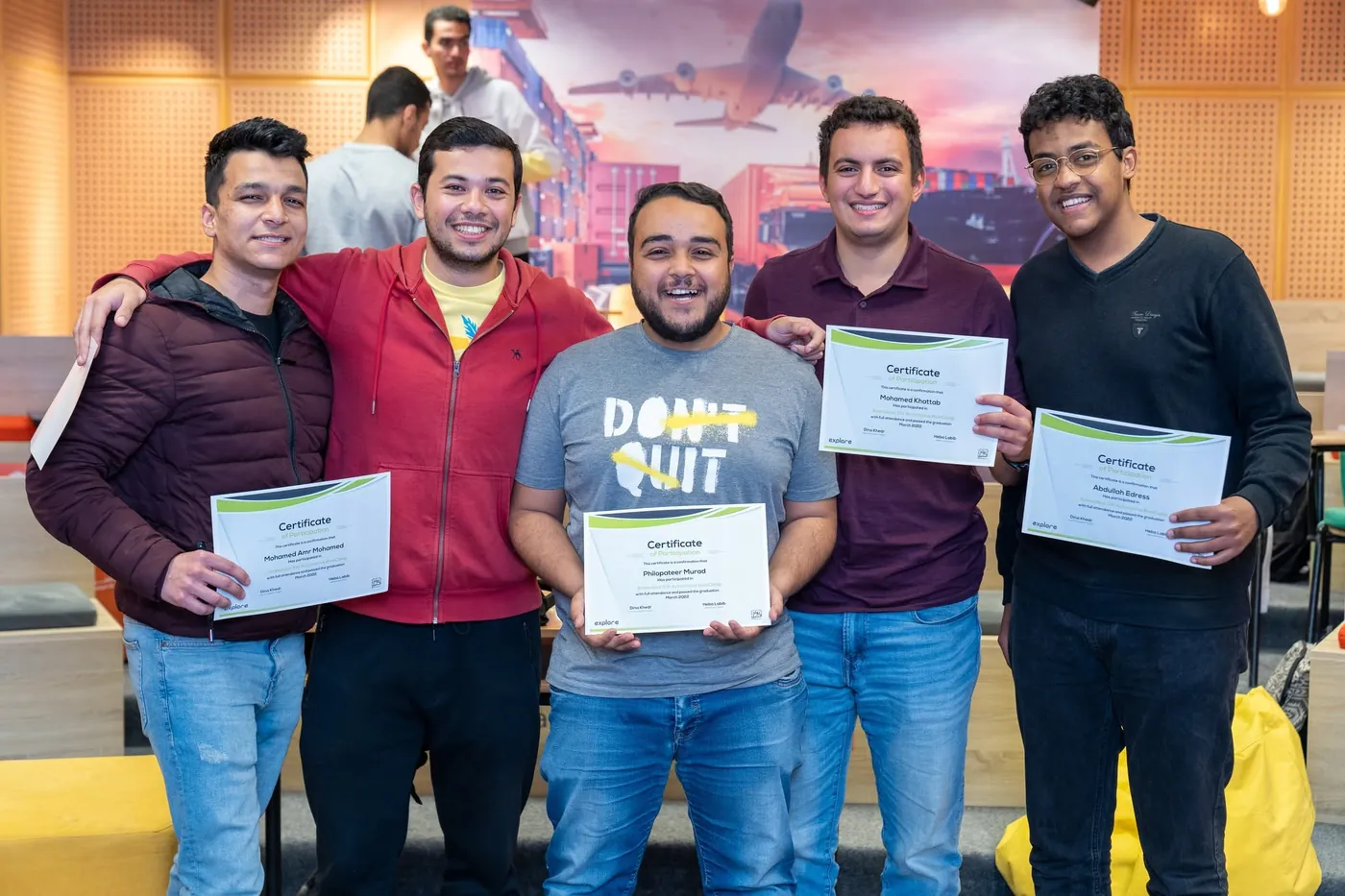 Graduates holding their certificates