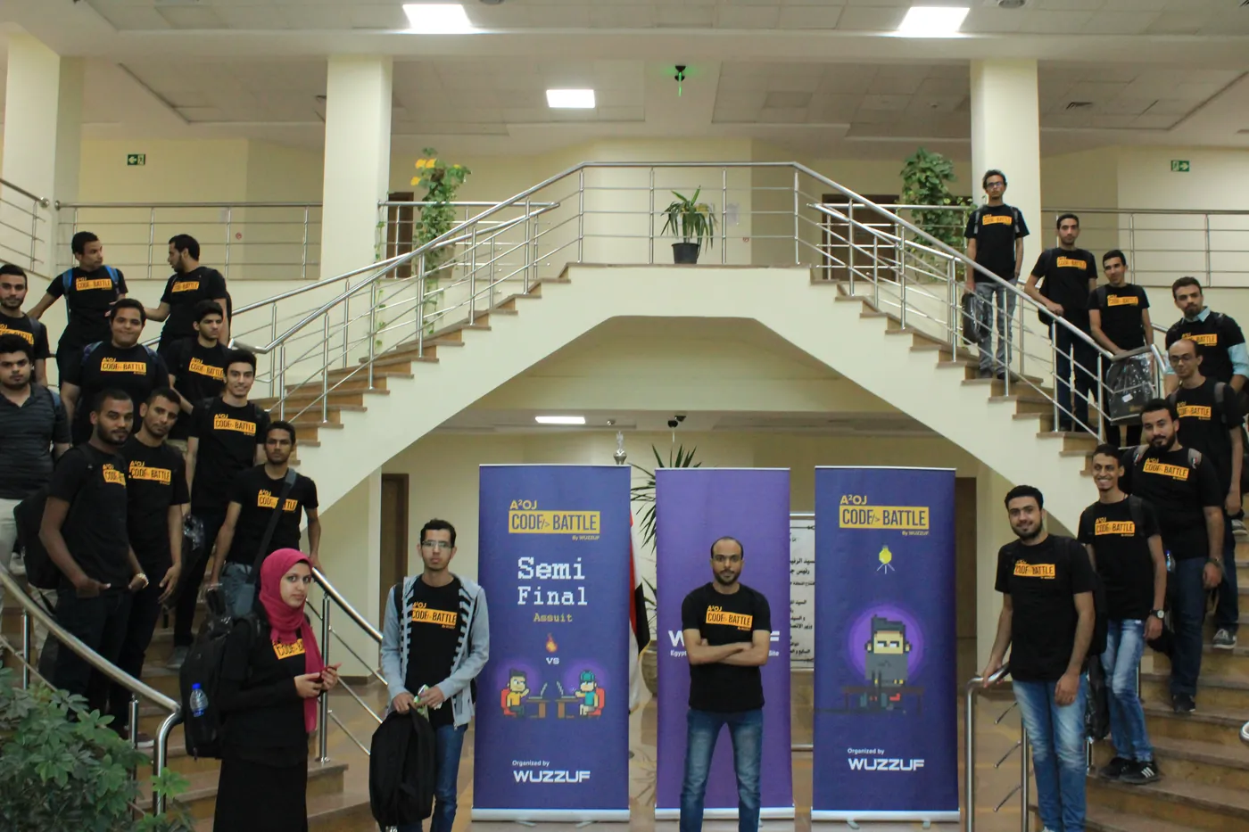 Code Battle semi-finalists in Assiut with the semi-final banners